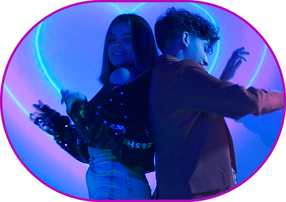 Still from the film "Bety Catfur". Two-shot. Blue color scheme. Two young people in a chill dance in front of neon hearts.